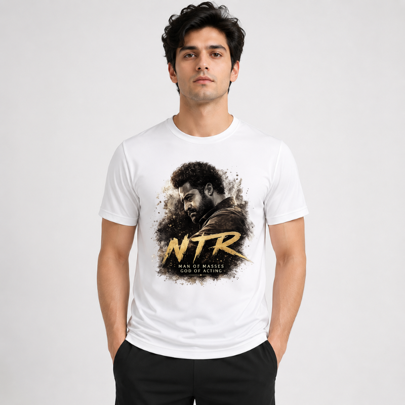 Young man wearing a premium white custom-printed Jr. NTR t-shirt featuring a stylized artistic portrait of the actor with bold brush strokes and the text "NTR Man of Masses God of Acting" from CustomPe.